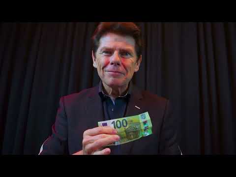 Magician Tony Price performs a cool trick where he transforms a 10 euro bill into a hundred euro bill.
